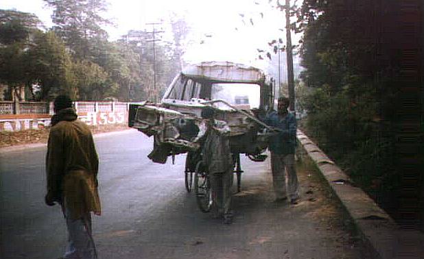 The humble but ubiquitous rickshaw, whose contribution to the Indian Economy perhaps equals those of many large industries. Note the front wheel is not on the ground.